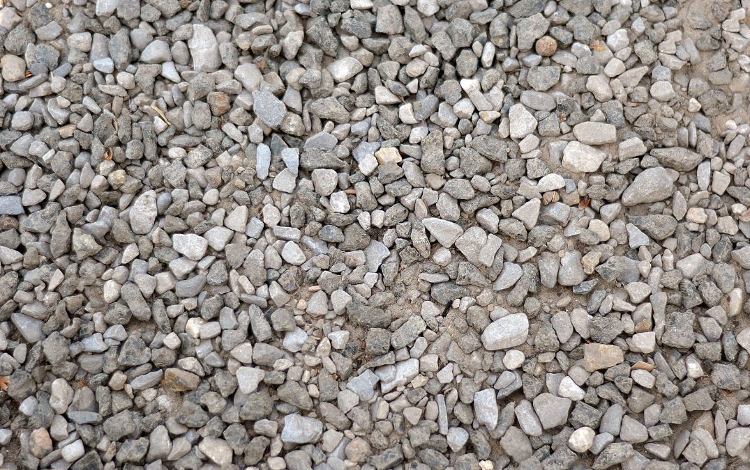Gravel laid over the top of compressed soil, acting as reinforcement for fresh concrete.